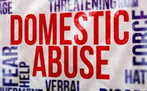 Graphic of the words domestic abuse surrounded by words relating to abusive actions and emotions