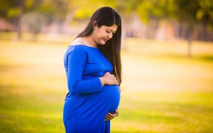 Heavily pregnant woman holding her bump