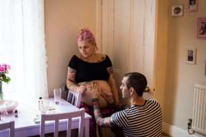 Man massaging his partner's belly during labour at an unassisted home birth