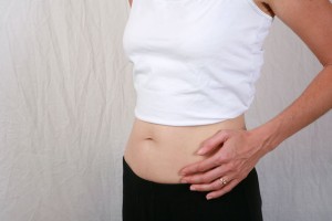  Closeup of pregnant womans stomach bump at 8 weeks gestation